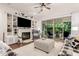 Comfortable living room with a fireplace, built-in shelving, and backyard views at 2879 E Austin Dr, Gilbert, AZ 85296