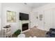 Well-lit living room with an electric fireplace, wall-mount television, and neutral decor at 2879 E Austin Dr, Gilbert, AZ 85296