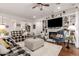 Spacious living room featuring a fireplace, built-in shelving, and hardwood floors at 2879 E Austin Dr, Gilbert, AZ 85296