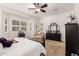 Bright main bedroom boasts a plush chaise lounge, dark dresser, neutral carpet, and shuttered windows for ample light at 2879 E Austin Dr, Gilbert, AZ 85296