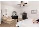 Bright and airy main bedroom featuring a chaise lounge, a black dresser, carpeted floors, and neutral walls at 2879 E Austin Dr, Gilbert, AZ 85296
