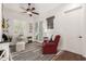Bright office space with a striped rug, shuttered windows, and a comfortable red chair with a modern ceiling fan at 2879 E Austin Dr, Gilbert, AZ 85296