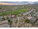 An overhead shot of a desert community, golf course, and distant mountain views at 31207 N 124Th Dr, Peoria, AZ 85383