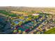 Aerial view showcasing the community's lush golf course, pools, tennis courts, and desert surroundings at 31207 N 124Th Dr, Peoria, AZ 85383