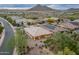An elevated view showcases the home's landscaping, putting green, and mountain views at 31207 N 124Th Dr, Peoria, AZ 85383