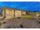A serene backyard showcasing a pristine putting green, stone landscaping, and a covered patio at 31207 N 124Th Dr, Peoria, AZ 85383