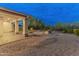 An attractive backyard with stone landscaping, a brick patio, and well-maintained desert foliage at 31207 N 124Th Dr, Peoria, AZ 85383