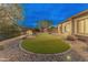 Backyard with a synthetic putting green, desert landscaping, and a block wall for privacy at 31207 N 124Th Dr, Peoria, AZ 85383