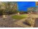 Desert landscaped backyard with a synthetic putting green, privacy fencing, and a desert feel at 31207 N 124Th Dr, Peoria, AZ 85383