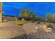 Backyard featuring desert landscaping, a small putting green, rock accents, and privacy fencing at 31207 N 124Th Dr, Peoria, AZ 85383