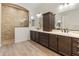 A primary bathroom featuring dual sinks, sleek cabinetry, and a large, tiled walk-in shower at 31207 N 124Th Dr, Peoria, AZ 85383