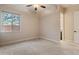 Bedroom with large window for natural light, plush carpets, and view to ensuite bathroom at 31207 N 124Th Dr, Peoria, AZ 85383