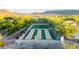Aerial view of bocce ball courts surrounded by desert vegetation and seating areas, a recreational amenity at 31207 N 124Th Dr, Peoria, AZ 85383