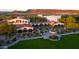 Aerial view of the beautiful clubhouse with manicured lawn, elegant architecture, and inviting outdoor spaces at 31207 N 124Th Dr, Peoria, AZ 85383