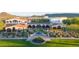 Stunning clubhouse featuring manicured landscaping, elegant architecture, and inviting outdoor spaces at 31207 N 124Th Dr, Peoria, AZ 85383