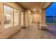 Covered patio with stone pillars offering glimpses of the backyard and the dining room through windows at 31207 N 124Th Dr, Peoria, AZ 85383