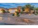 Charming single-story home featuring desert landscaping, a two-car garage, and stone accents at 31207 N 124Th Dr, Peoria, AZ 85383