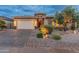 Beautiful single-story home featuring a three-car garage, stone accents and manicured landscaping at 31207 N 124Th Dr, Peoria, AZ 85383