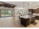 A contemporary kitchen featuring a large granite island, stainless appliances, and dark cabinets at 31207 N 124Th Dr, Peoria, AZ 85383