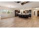 An open kitchen features dark wood cabinets, stainless appliances, and a spacious island with seating at 31207 N 124Th Dr, Peoria, AZ 85383