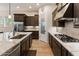 A kitchen featuring dark wood cabinets, stainless appliances, and granite countertops at 31207 N 124Th Dr, Peoria, AZ 85383