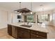 Kitchen island with granite countertops, stainless steel appliances and dark wood cabinets at 31207 N 124Th Dr, Peoria, AZ 85383