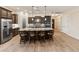 Kitchen featuring a spacious granite island with seating, stainless fridge, and modern appliances at 31207 N 124Th Dr, Peoria, AZ 85383