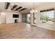 The living room features a large window, ceiling fan and access to the back yard at 31207 N 124Th Dr, Peoria, AZ 85383