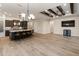 Open concept living space with a large island, granite countertop, and wood beam ceiling at 31207 N 124Th Dr, Peoria, AZ 85383