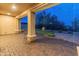 A lovely patio area featuring a brick floor, stone pillars, and ornate furniture at 31207 N 124Th Dr, Peoria, AZ 85383