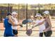 Group of women playing pickleball on a court, enjoying the community's active lifestyle at 31207 N 124Th Dr, Peoria, AZ 85383