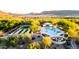 Aerial view of community pool and recreation area with lounge chairs, cabanas, and mature landscaping at 31207 N 124Th Dr, Peoria, AZ 85383