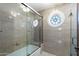 Modern bathroom with glass shower door and round stained glass window at 3160 E Fox St, Mesa, AZ 85213
