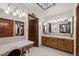 Bathroom with dual sinks, vanity, and stained glass skylight at 3160 E Fox St, Mesa, AZ 85213