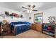 Neutral bedroom enhanced by a ceiling fan, window, and built-in shelving at 3160 E Fox St, Mesa, AZ 85213