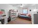 Bedroom featuring a bed with storage and a window with charming patterned valance at 3160 E Fox St, Mesa, AZ 85213