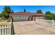 Spacious garage with a large driveway and a well-manicured yard at 3160 E Fox St, Mesa, AZ 85213