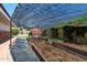 Vegetable garden with raised beds and protective shade covering at 3160 E Fox St, Mesa, AZ 85213