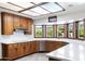 Updated kitchen featuring wooden cabinetry, white countertops, and a view of the backyard at 3160 E Fox St, Mesa, AZ 85213