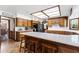 Bright kitchen with white countertops, wooden cabinets, and a skylight for natural light at 3160 E Fox St, Mesa, AZ 85213