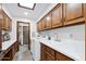 Functional laundry room with washer, dryer, sink, and ample overhead cabinet space at 3160 E Fox St, Mesa, AZ 85213