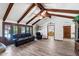 Comfortable living room with wood-look floors, beamed ceilings, and natural light from French doors at 3160 E Fox St, Mesa, AZ 85213