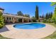 Backyard pool with patio, lush lawn, and mature trees at 3160 E Fox St, Mesa, AZ 85213