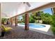Outdoor pool area with covered patio and lush landscaping at 3160 E Fox St, Mesa, AZ 85213