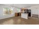 Bright kitchen with wood cabinets, stainless appliances, and an eat-in area by large windows at 3221 W Alta Vista Rd, Phoenix, AZ 85041