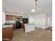 Bright kitchen featuring an island, tile floors, and stainless steel appliances at 3221 W Alta Vista Rd, Phoenix, AZ 85041