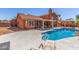 Enjoy the backyard oasis with a sparkling pool, patio, and lush landscaping at 3424 E Harmony Ave, Mesa, AZ 85204