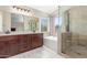 Modern bathroom features a soaking tub, glass shower, and a double sink vanity at 3424 E Harmony Ave, Mesa, AZ 85204
