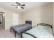 Cozy bedroom featuring twin beds, neutral walls, and a ceiling fan for added comfort at 3424 E Harmony Ave, Mesa, AZ 85204