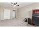 Bedroom with desk, shelving unit, and carpet flooring at 3424 E Harmony Ave, Mesa, AZ 85204